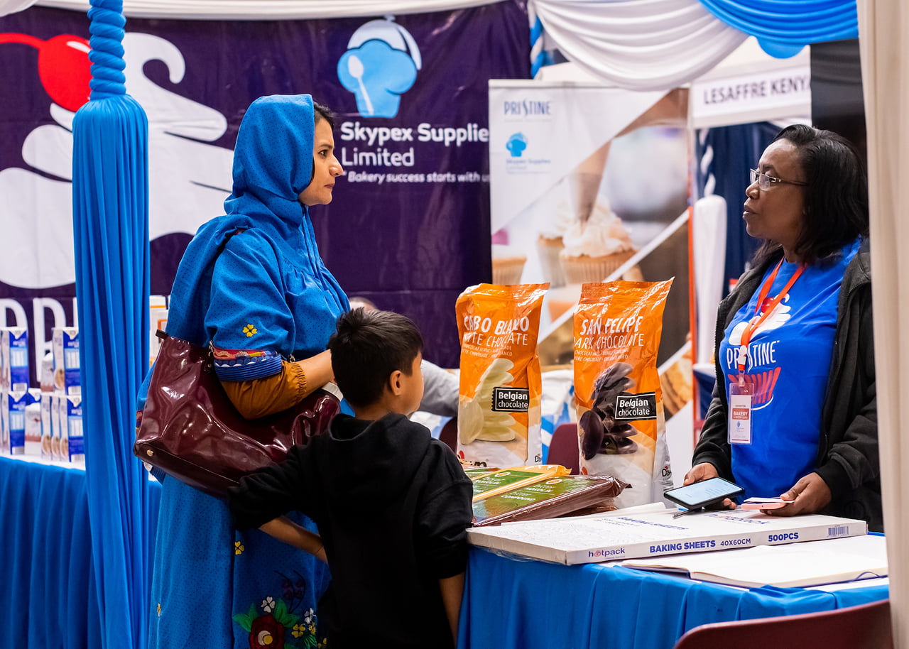 Discussing products at a bakery expo.