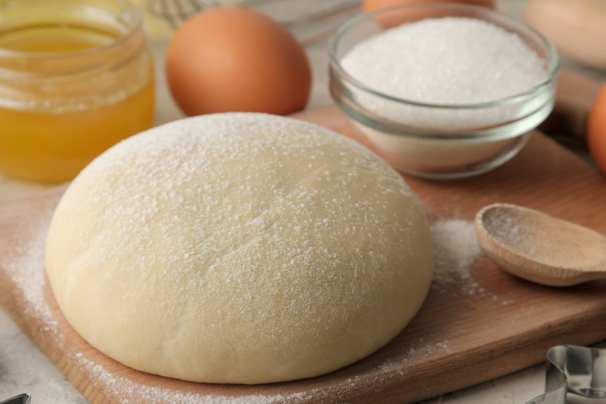 Baking ingredients with dough, sugar, and eggs.